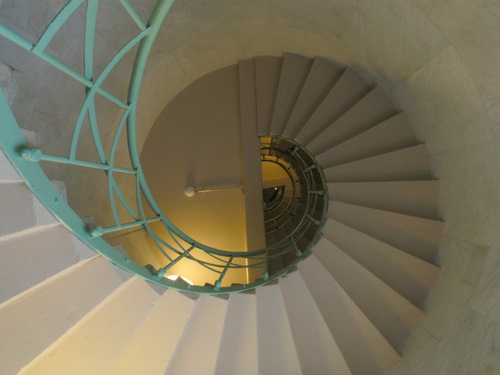  a spiral staircase with interim rest stations.